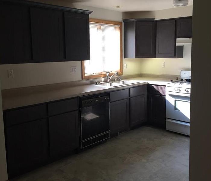 Kitchen with brand new dark wood cabinets with a new tile floor
