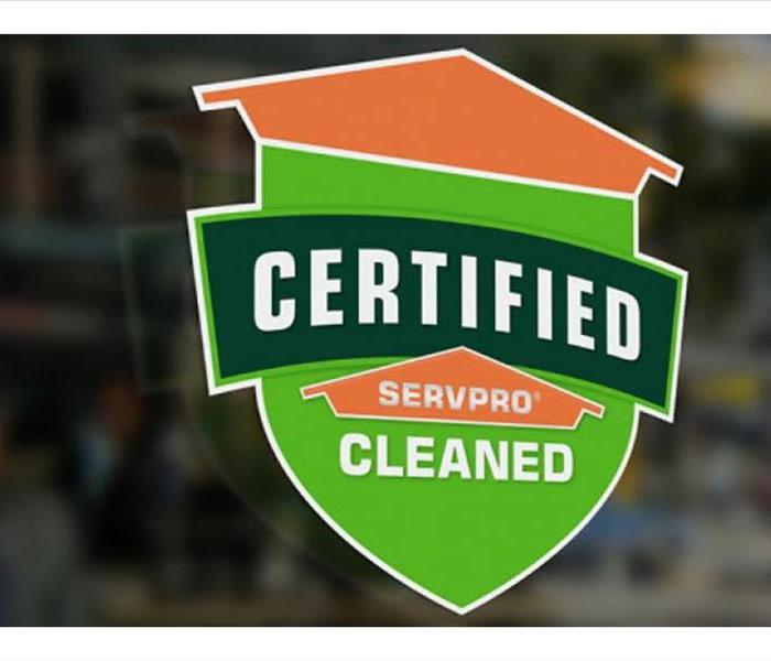 A phot of our orange and green Certified: SERVPRO Cleaned window seal